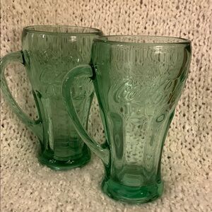 Set of 2 Coca Cola green glass mugs, approximately 6.5 inches tall.